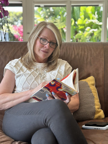 Woman reading a book and wearing Connect full frame Reading Glasses